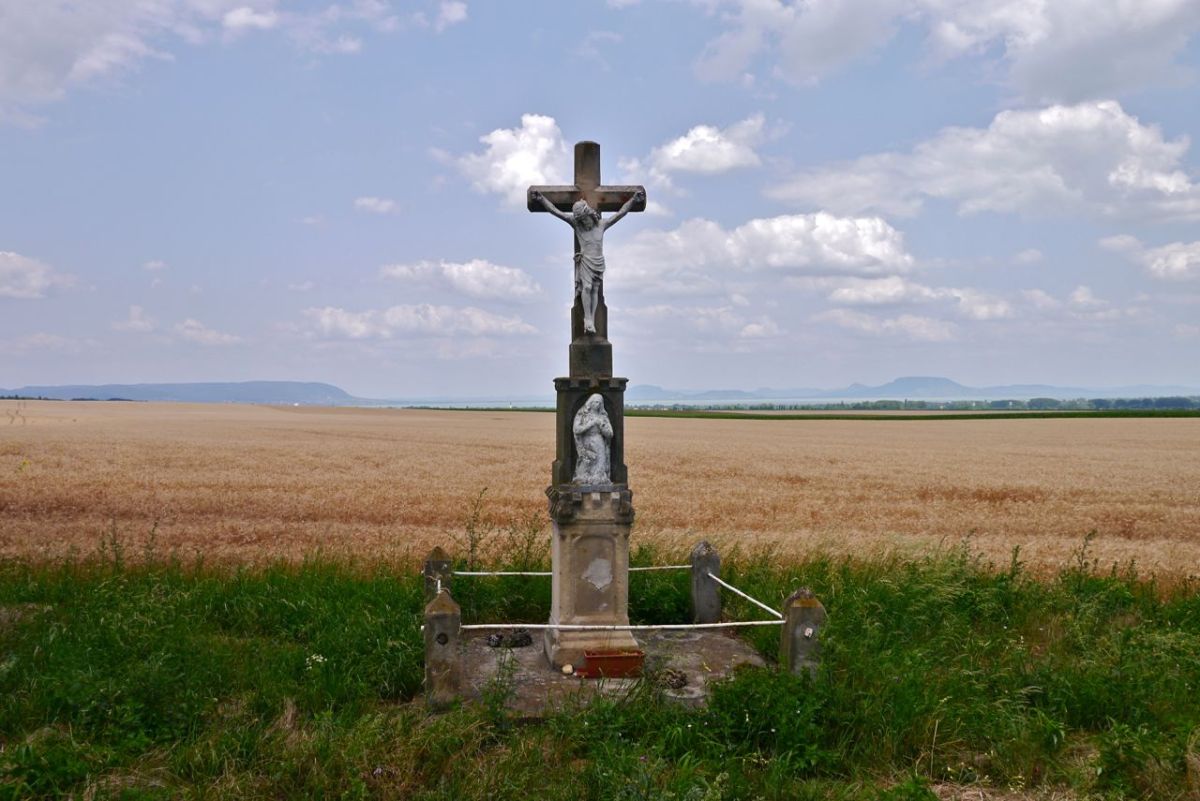 Shrine by the road side. Balaton lake is behind the field.