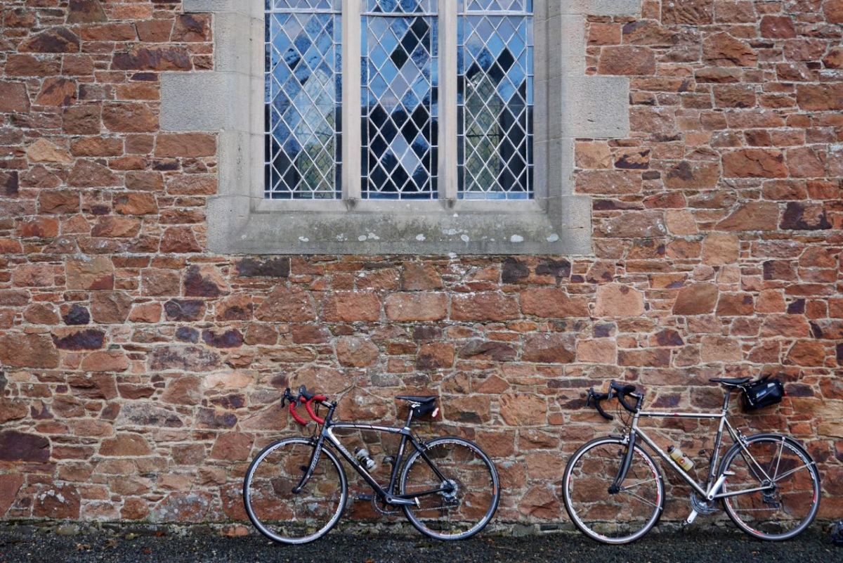 Bike in front of a church window.